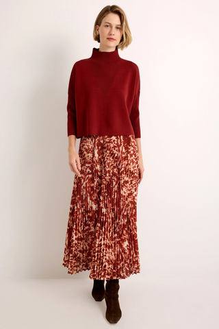 Wesley Skirt in Calico featuring a red and ivory printed pleated maxi silhouette with a contrasting auburn waistband.