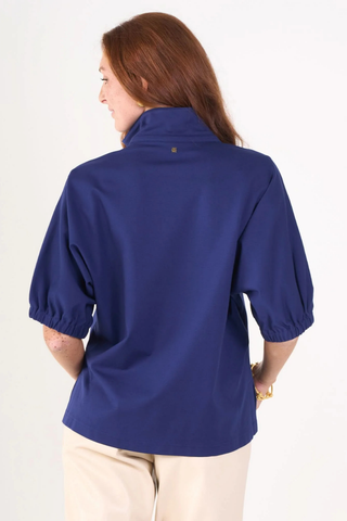 Model wearing the Emily McCarthy Poppy Top in Navy Cotton Poplin with relaxed dolman sleeves and a notched neckline.