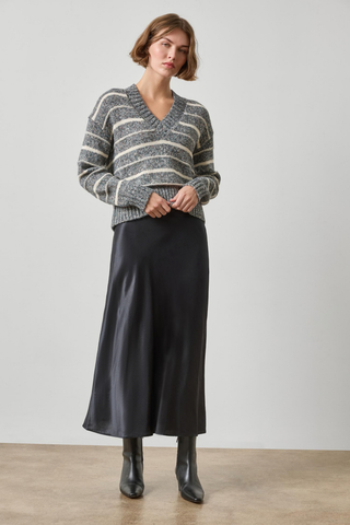 Woman wearing the Lilla P Multi Stripe V-Neck Sweater in Shadow Stripe, a relaxed grey and white striped knit sweater.