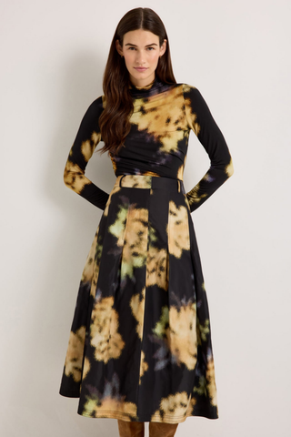 Marie Oliver Eloise Top in Lush featuring a black and yellow abstract floral print, fitted long sleeves, and sleek turtleneck silhouette.