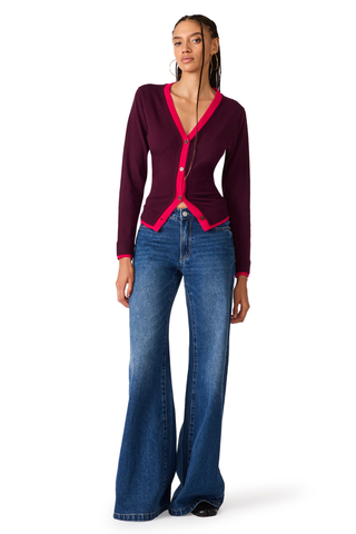 Deep fig fitted cardigan with contrast pink trim and button-front closure.