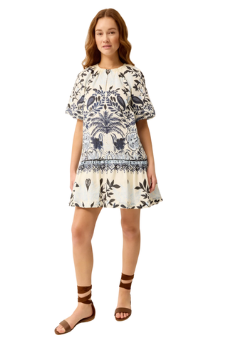 Woman wearing a patterned dress on a white background