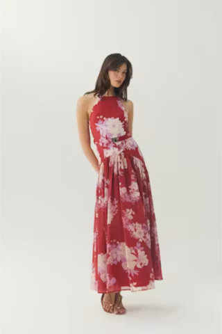 Red and ivory floral sleeveless maxi dress with a flowing skirt.