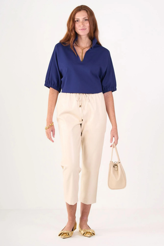 Model wearing the Emily McCarthy Poppy Top in Navy Cotton Poplin with relaxed dolman sleeves and a notched neckline.