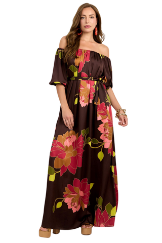 Trina Turk Voglia Dress in Multi featuring a bold floral print, off-the-shoulder neckline, puff sleeves, sash waist, and flowing maxi silhouette.