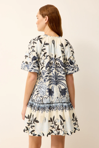 Woman wearing a floral dress with a neutral background