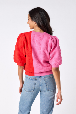 Crosby Smith Sweater in Crosby Colorblock featuring a pink and red colorblock design, crew neckline, and short puff sleeves.
