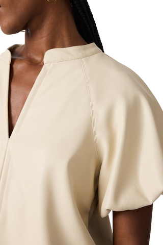 Bone blouse with flutter sleeves and a relaxed draped silhouette.