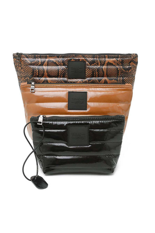 Think Royln Travel Trio set of three quilted pouches in Neo Python print, cocoa brown, and black.