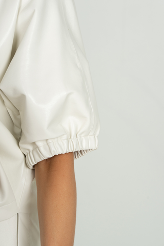 Emily McCarthy Poppy Top in Carrara white featuring a collared V-neckline, short gathered puff sleeves, and relaxed silhouette.