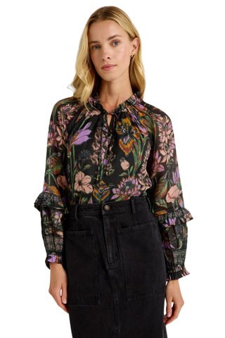 Marie Oliver Umika Top in Nightshade featuring a dark floral print, V-neckline, ruffle details, and long fluid sleeves.