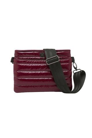 Shop the Think Royln Bum Bag 2.0 in Glossy Deep Burgundy, a lightweight quilted bag with adjustable straps and hands-free versatility.