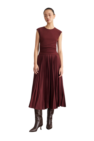 Tanya Taylor Carly Dress in Deep Redwood burgundy with cap sleeves, a ruched fitted waist, and flowing pleated midi skirt.