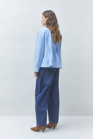 Suncoo Loeli Blouse in Bleu Ciel featuring a light blue hue, gathered high neckline, long sleeves, and flowy silhouette.