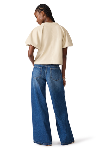 Bone blouse with flutter sleeves and a relaxed draped silhouette.