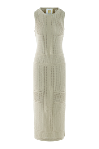 Model wearing the Emily McCarthy Bali Dress in Sand featuring a sleeveless open-knit design, midi length silhouette, textured detailing, and side slit accents