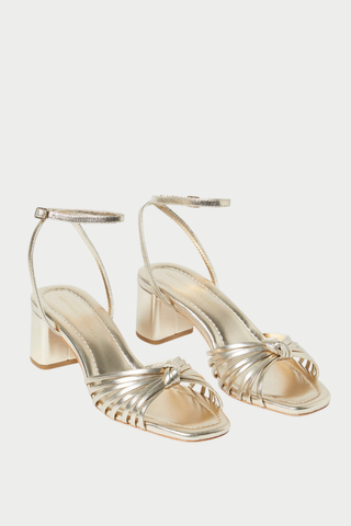 Loeffler Randall Olivia Mid Heel Sandal in champagne metallic leather with a knotted upper, ankle strap, and block heel.
