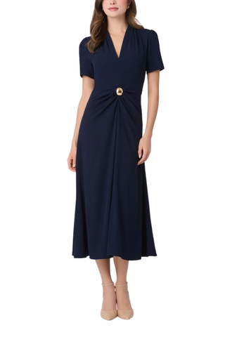 Shoshanna Waldorf Dress in navy featuring a draped V-neckline, short sleeves, gold waist detail, and flared midi skirt.