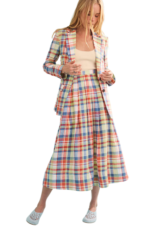 Woman wearing a colorful plaid suit on a white background