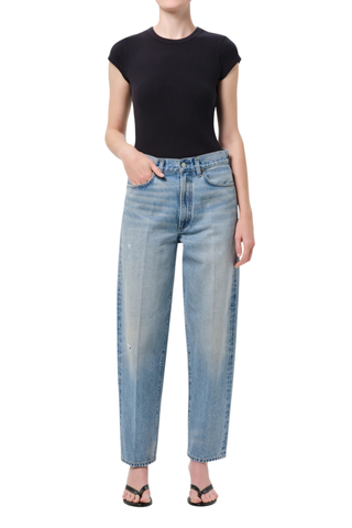 Model wearing AGOLDE The 80’s Jean in Orbital, a high-rise straight-leg rigid denim jean in a medium vintage indigo wash