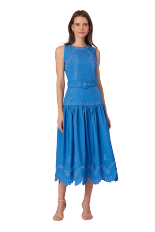 Model wearing the Shoshanna Lennon Dress in Marina, a sleeveless blue midi dress with a fitted bodice, textured detailing, and flowing skirt.