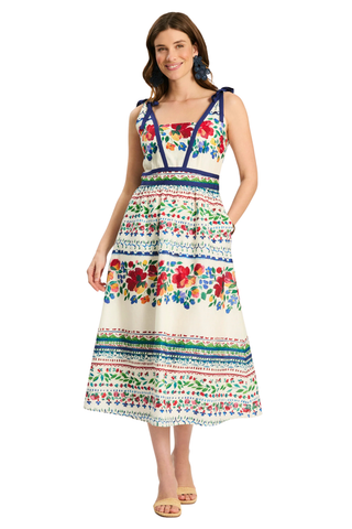 Woman wearing a colorful floral dress on a white background