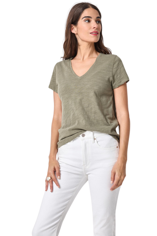 Model wearing the Lilla P Short Sleeve Back Seam V-Neck in Fern featuring soft slub cotton fabric, short sleeves, a V-neckline, and subtle back seam detail paired with white denim jeans