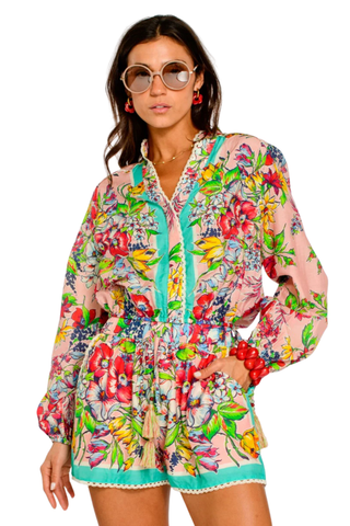 Model wearing the Elizabeth James the Label Emmett Top in Vintage Scarf featuring a colorful floral scarf-inspired print, balloon sleeves, tassel drawstring waist, crochet trim accents, and relaxed resort-ready silhouette paired with matching shorts