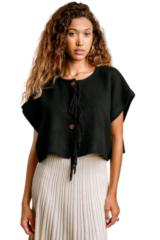Kerisma Sachi Vest in Black featuring a cropped silhouette, short sleeves, and fringed button front in soft marled yarn.