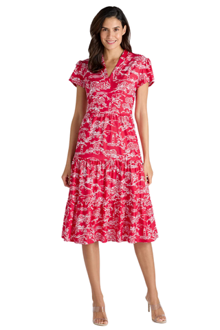 Woman wearing a red and white patterned dress on a white background