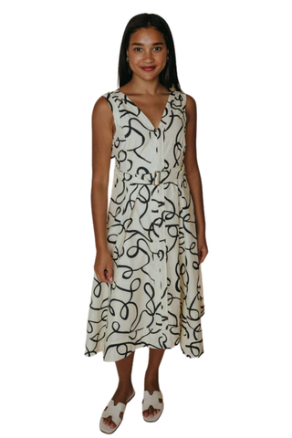 Woman wearing a sleeveless dress with a black pattern on a white background