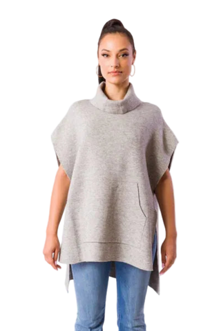 Kerisma Kanga Poncho in Light Khaki featuring a relaxed draped silhouette, cowl neckline, short sleeves, kangaroo pocket, and side slits.