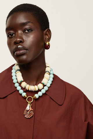 Desert Bloom Necklace in Amazonite with pale blue-green beads, gold-plated hardware, pearl, coral-inspired and carved flower charms.