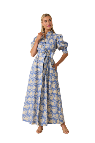 Model wearing the Prosperina Marianne Maxi Dress in Bloomport Print featuring a blue floral print, fitted bodice, and flowing full-length skirt.