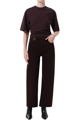 Model wearing the AGOLDE Ren Jean in Sloe Berry featuring a high-rise waist, cropped wide-leg silhouette, and rich dark grape denim with warm brown undertones.