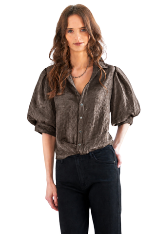 Finley Bomba Metallic Shirt in Brown featuring shimmering iridescent fabric, a spread collar, button-front closure, elbow-length blouson sleeves, and a flattering twisted front hem.