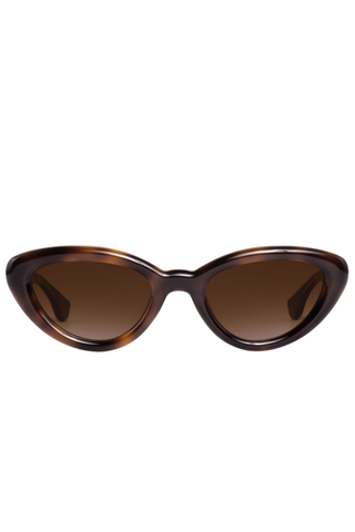 Krewe Sasha Sunglasses in Maple featuring a glossy brown cat-eye acetate frame and amber gradient lenses.