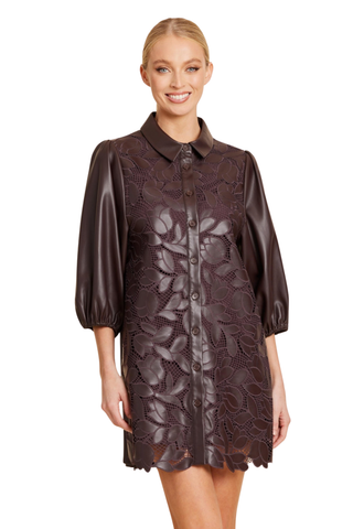 Dolce Cabo Laser Cut A-Line Dress in Coffee featuring brown faux leather, floral cutout detailing, puff sleeves, and an A-line mini silhouette.