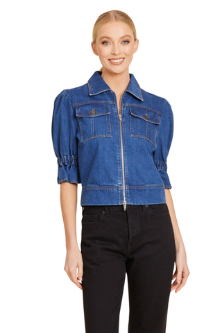Dolce Cabo Puff Sleeve Shacket in Denim featuring medium wash denim, elbow-length puff sleeves, a pointed collar, zip front, and chest flap pockets.