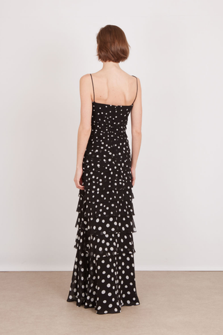 SALONI Niki Maxi Dress in Polka Scatter featuring a black and white polka-dot print, fitted bodice, thin straps, and floor-length skirt.