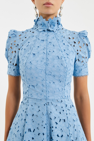 Rebecca Vallance Kitsu Midi Dress in blue broderie anglaise with floral neckline, short sleeves, and full midi skirt