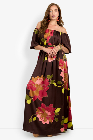 Trina Turk Voglia Dress in Multi featuring a bold floral print, off-the-shoulder neckline, puff sleeves, sash waist, and flowing maxi silhouette.