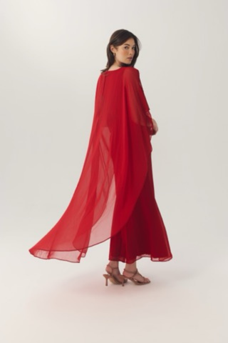 Elegant red gown with flowing chiffon cape sleeves.