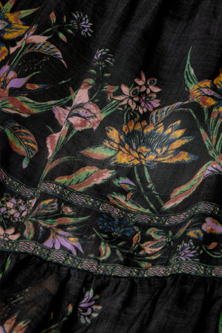 Marie Oliver Umika Top in Nightshade featuring a dark floral print, V-neckline, ruffle details, and long fluid sleeves.