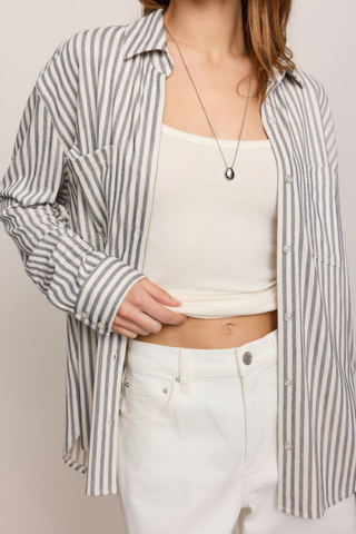 Model wearing the Z Supply Reese Button Up Stripe Top in Eclipse featuring striped knit fabric, long sleeves, and a relaxed fit.