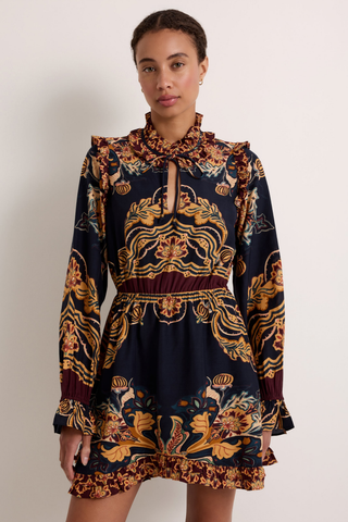Thalia Dress in Lasso featuring a navy Western-inspired print, long sleeves, ruffle detailing, and a handkerchief mini hem.