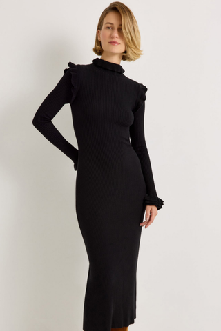 Marie Oliver Tinley Dress in Black featuring a fitted ribbed knit midi silhouette, fold-over ruffle turtleneck, and long sleeves with ruffled cuffs.