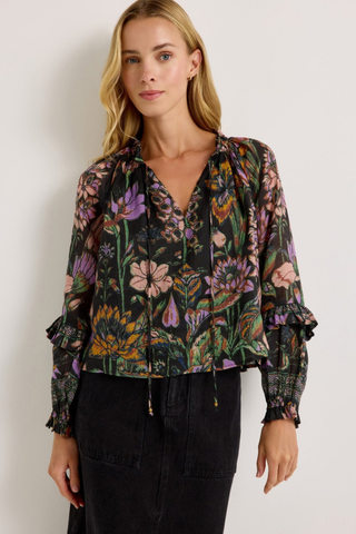 Marie Oliver Umika Top in Nightshade featuring a dark floral print, V-neckline, ruffle details, and long fluid sleeves.