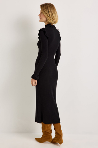 Marie Oliver Tinley Dress in Black featuring a fitted ribbed knit midi silhouette, fold-over ruffle turtleneck, and long sleeves with ruffled cuffs.
