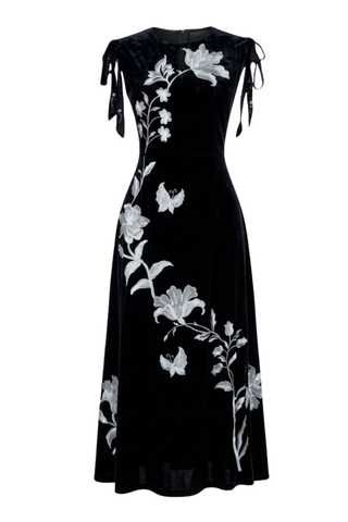 Fanm Mon Mualla Dress in Black + Silver featuring an off-the-shoulder neckline, sleek black maxi silhouette, and silver floral detailing.